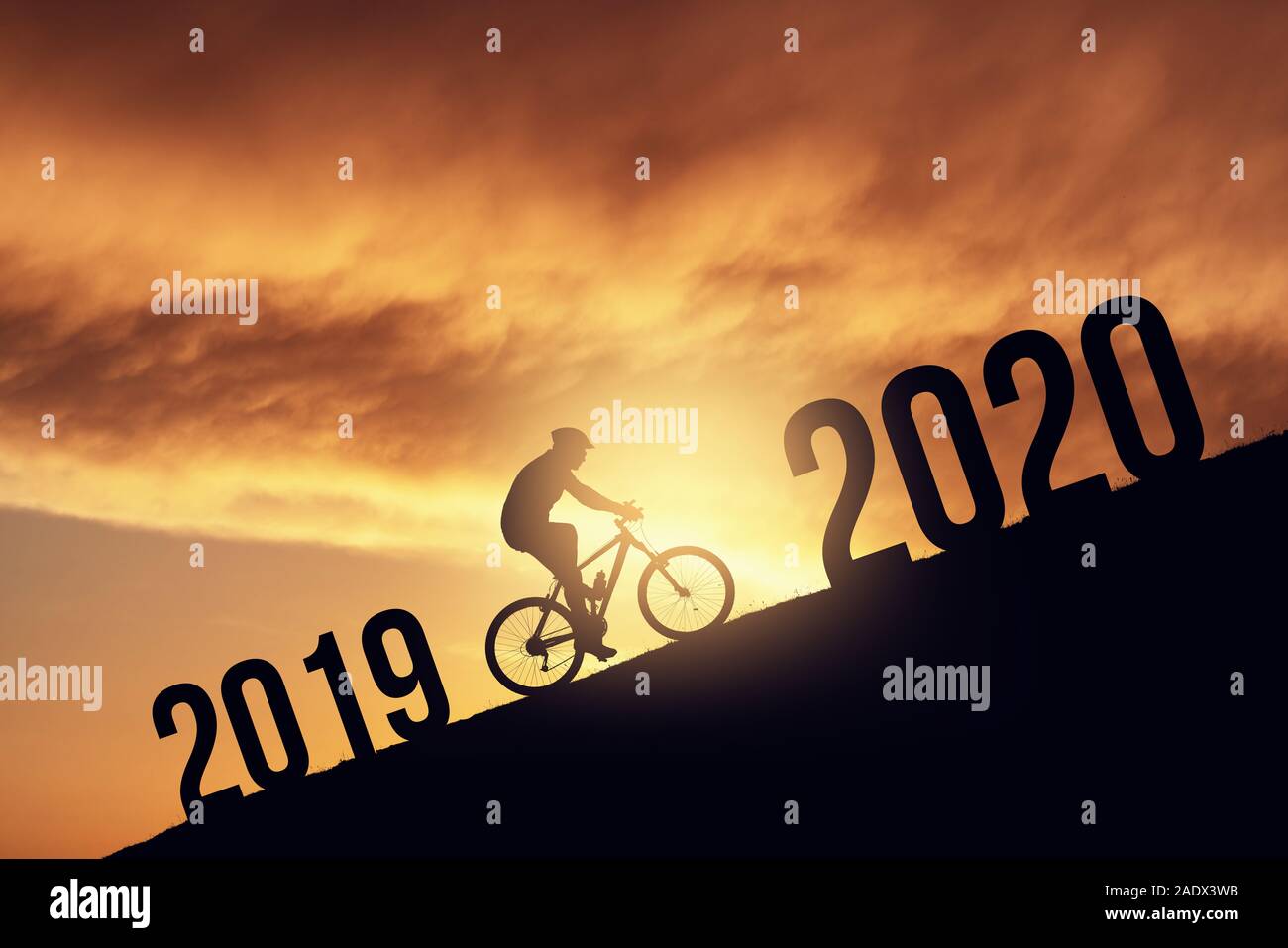 2020 new year concept with the silhoutte of a bicycle rider, metmorphing the changes of years. Stock Photo