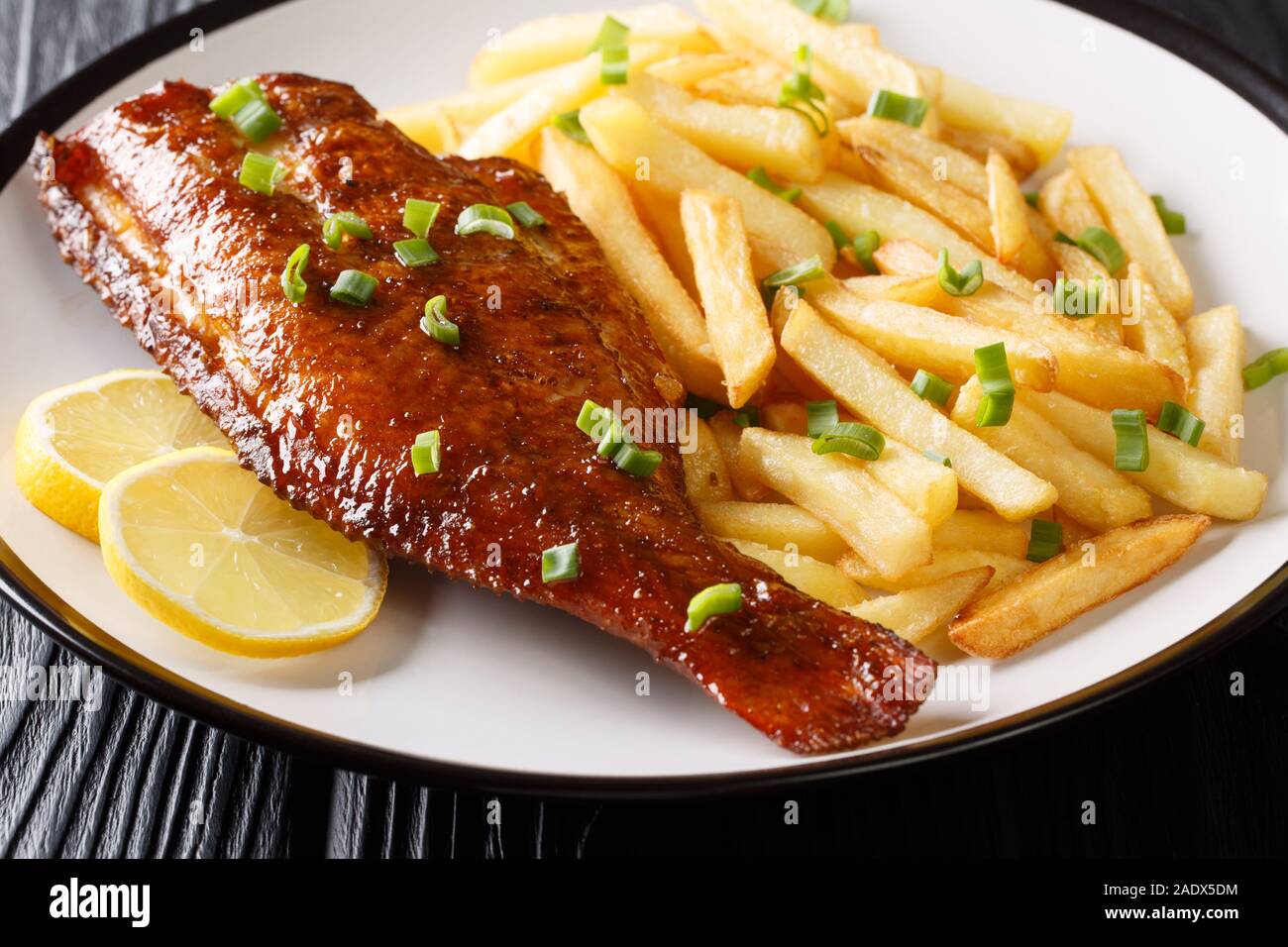 Fried Sebastes served with French fries close-up in a plate on the table. horizontal Stock Photo
