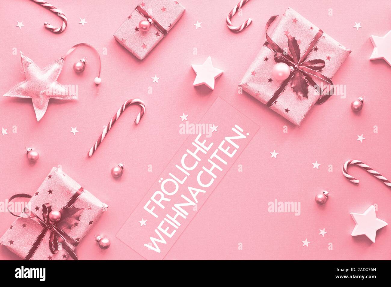 Festive monochrome pink Christmas background. Text "Frohliche