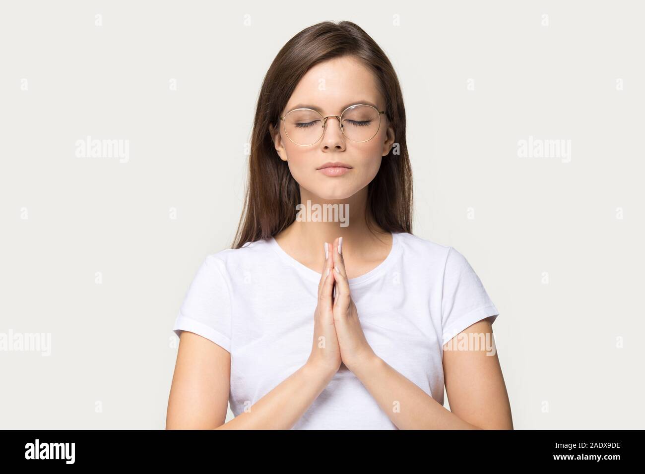 Headshot of calm beautiful young woman meditating with eyes closed ...