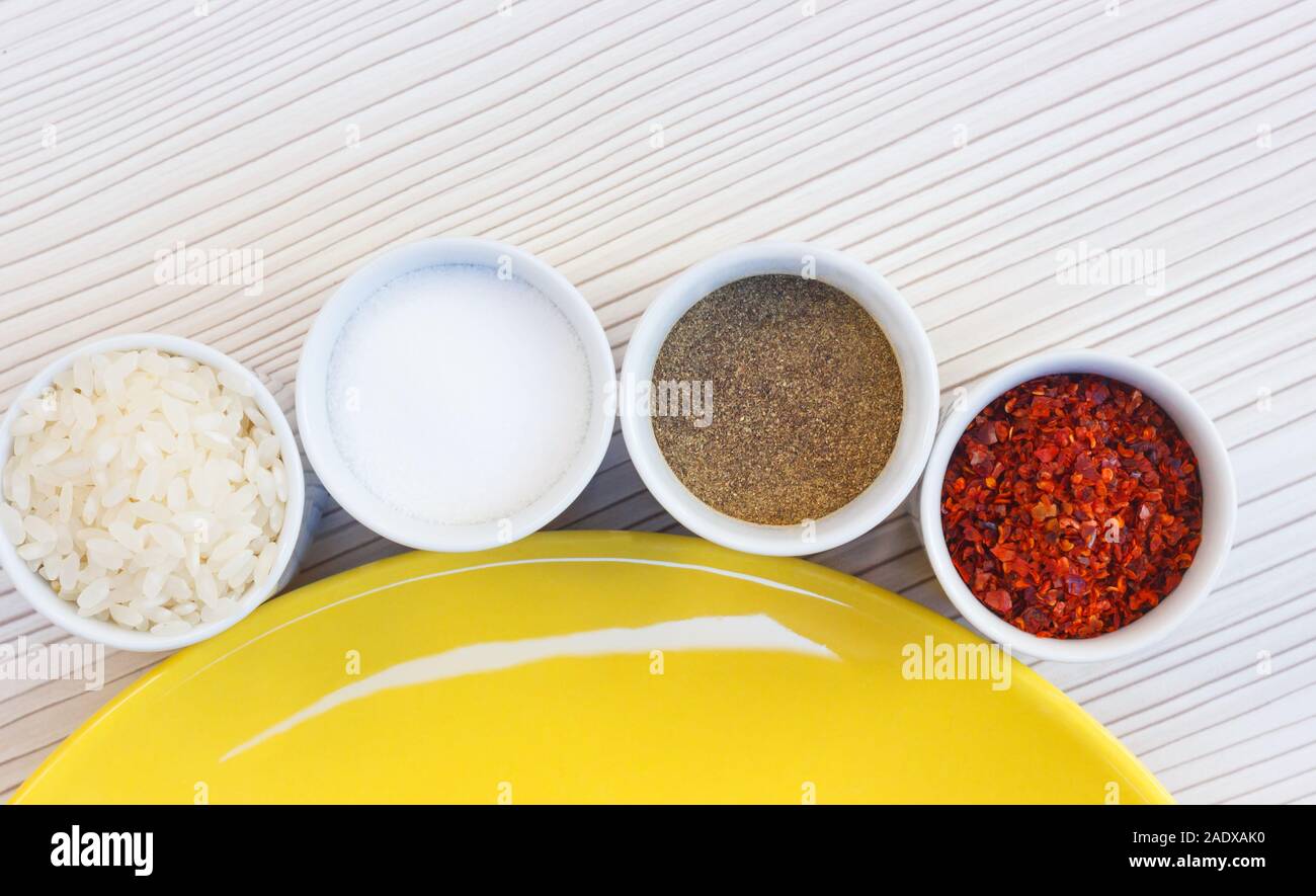 Salt rice with pepper, in small bowls Stock Photo Alamy