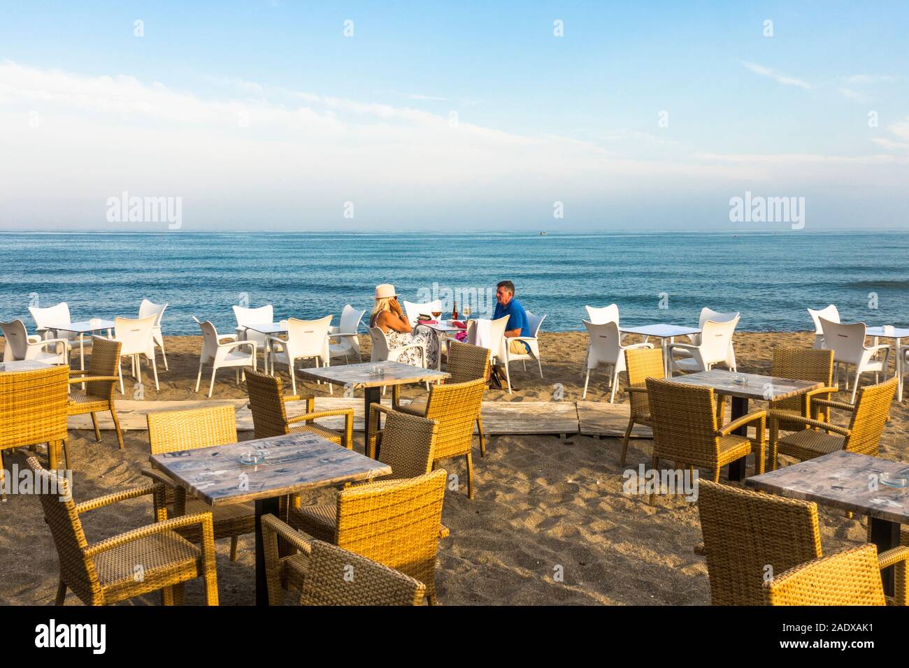 Couple alone on beach terrace, at mediterranean seaside. Costa del sol, Malaga, Spain. Stock Photo
