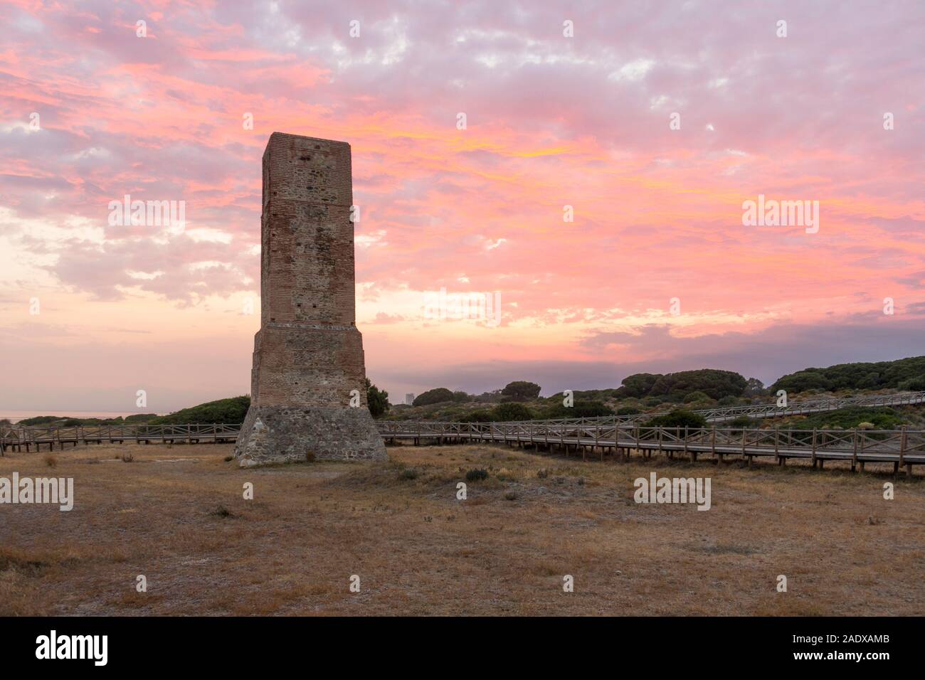 Moorish lookout tower, Thieves Tower, at beach Cabopino near Marbella, at sunset, Andalusia, Spain. Stock Photo