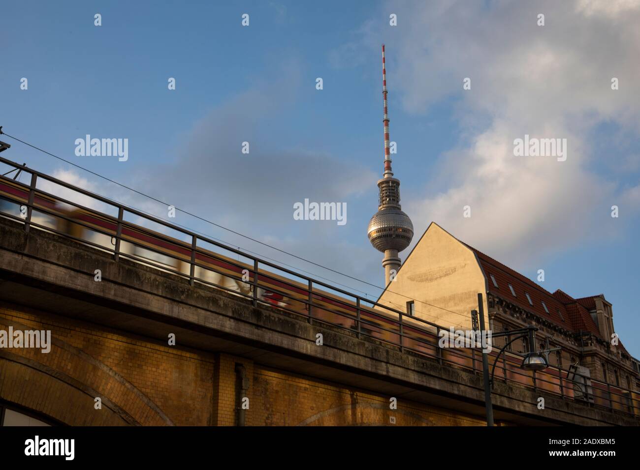 A train moving fast with the TV tower in the background Stock Photo