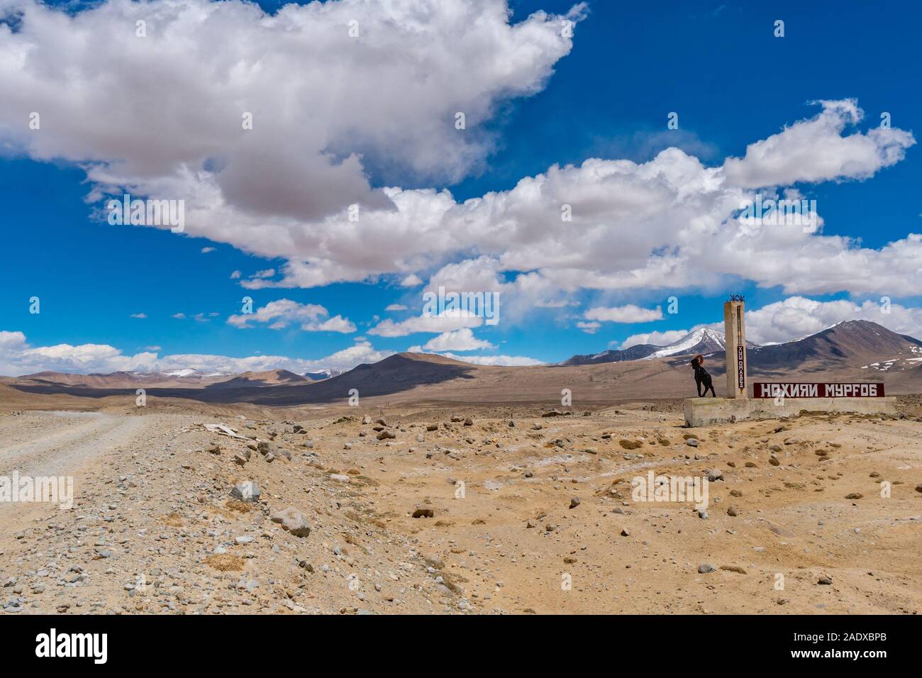 Pamir Highway M41 Murghab Rayon Billboard with an Ibex Sculpture on a Sunny Blue Sky Day Stock Photo