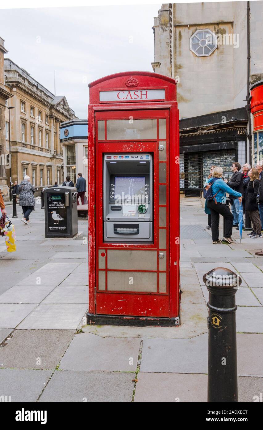Traditional British red phone boxes, now used as ATM , Cash machines, financial transactions. Bath, Somerset, England, UK. Stock Photo