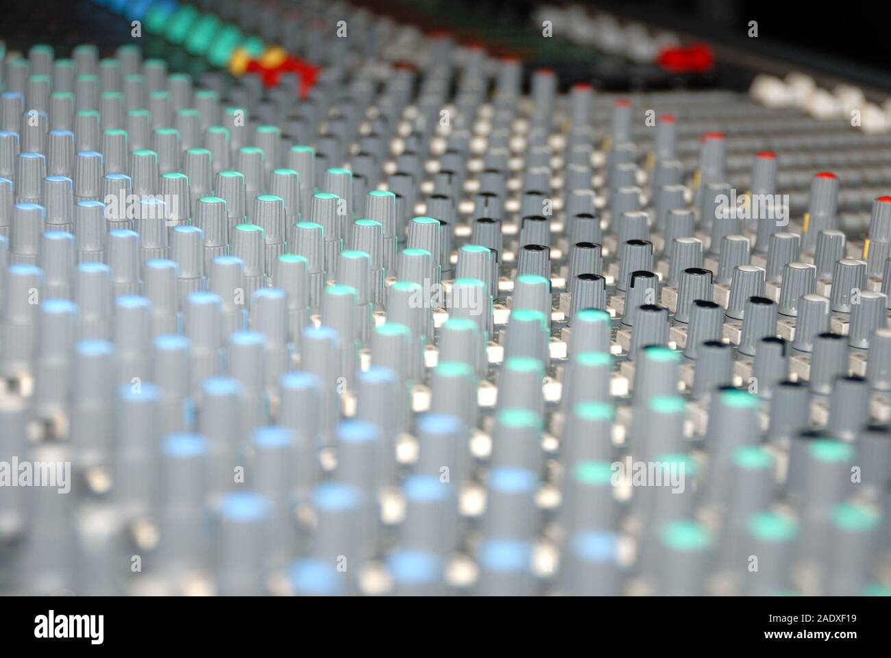 Audio mixing console in a recording studio. Faders and knobs of a sound