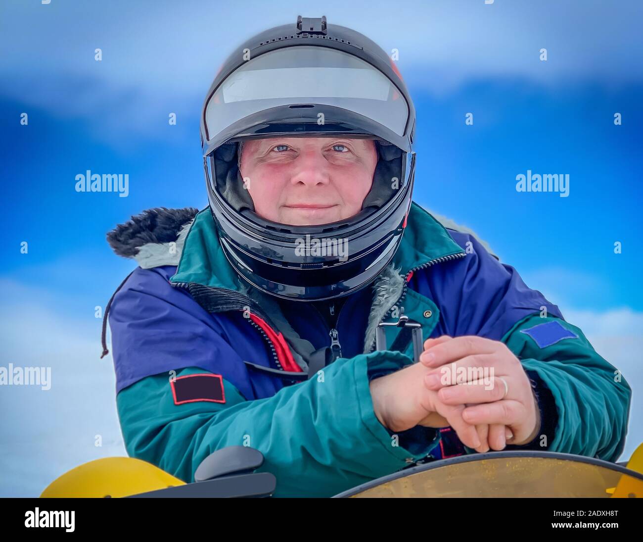 Portait of man on a snowmobile, wearing a helmet, Iceland Stock Photo
