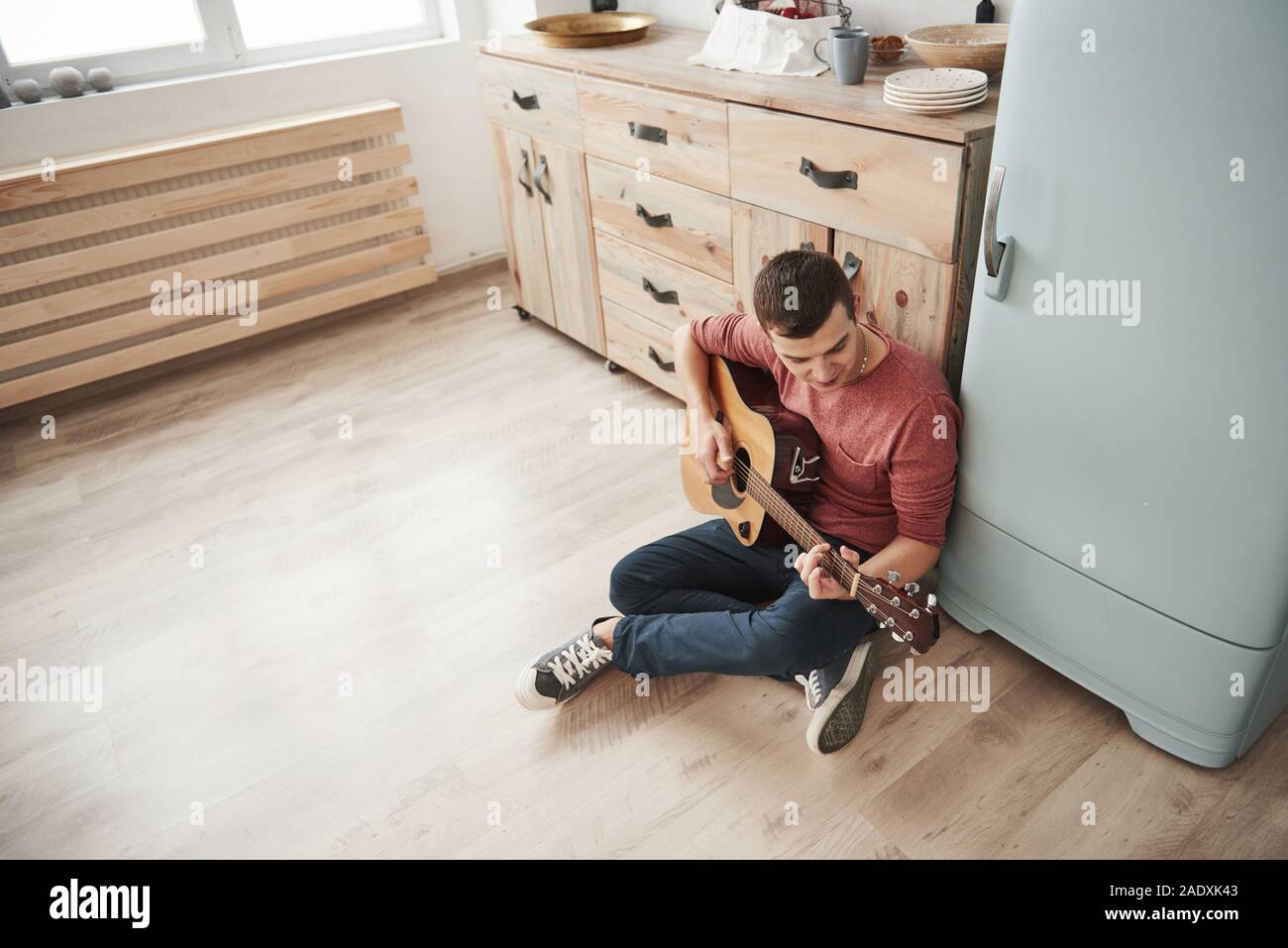Practice routine. Musician plays on acoustic guitar at home in the