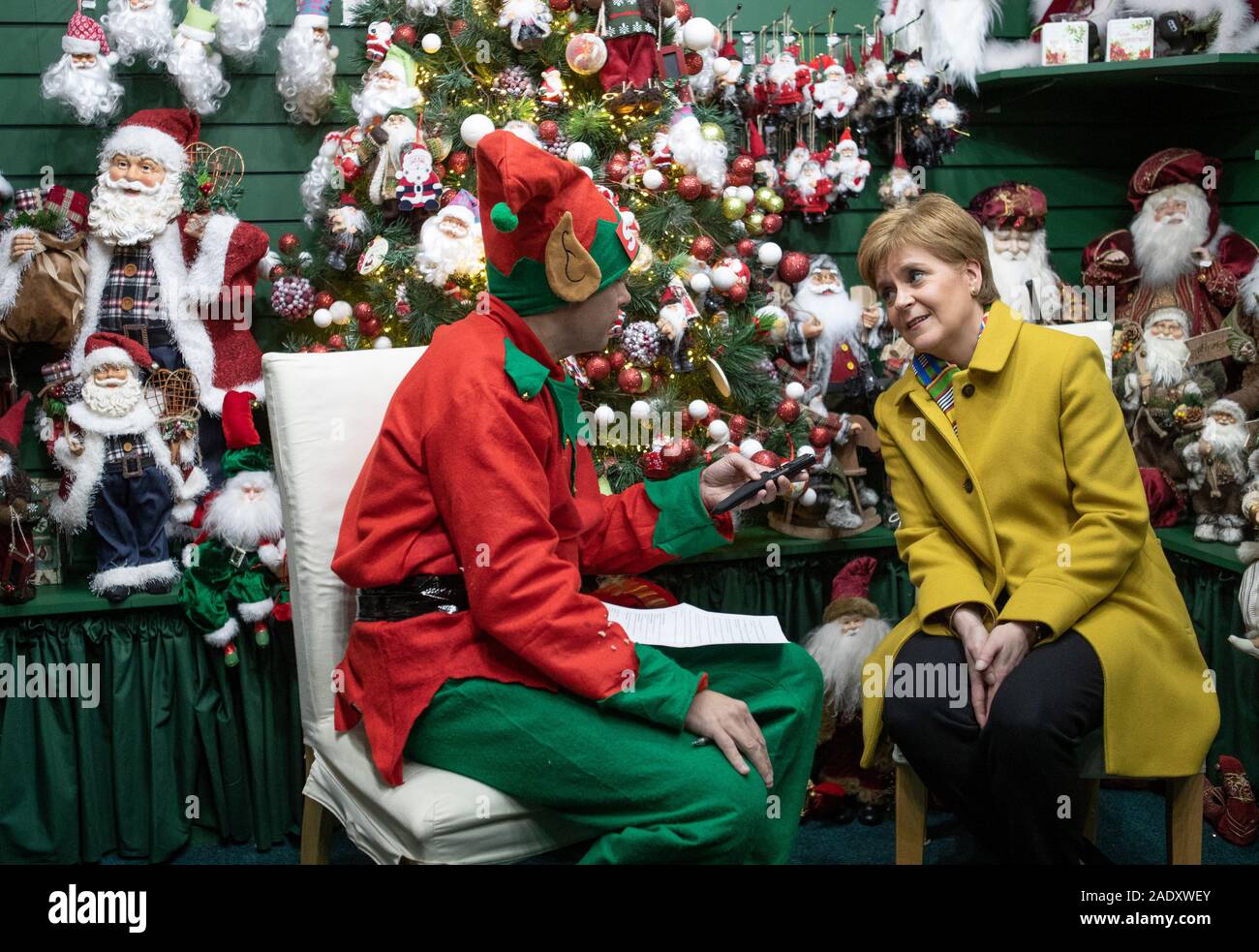 SNP leader Nicola Sturgeon is interviewed by a journalist dressed as a Christmas elf in the Nutcracker Christmas Village shop during a visit to Crieff Visitors Centre, Crieff, on the General Election campaign trail. Stock Photo