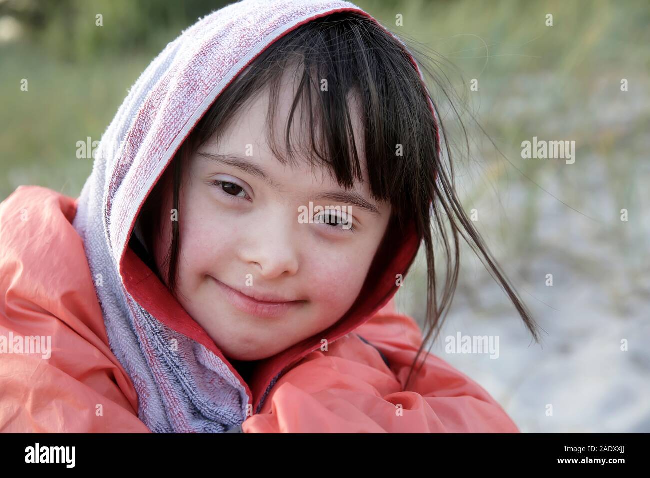 Portrait of little girl smiling outside Stock Photo - Alamy