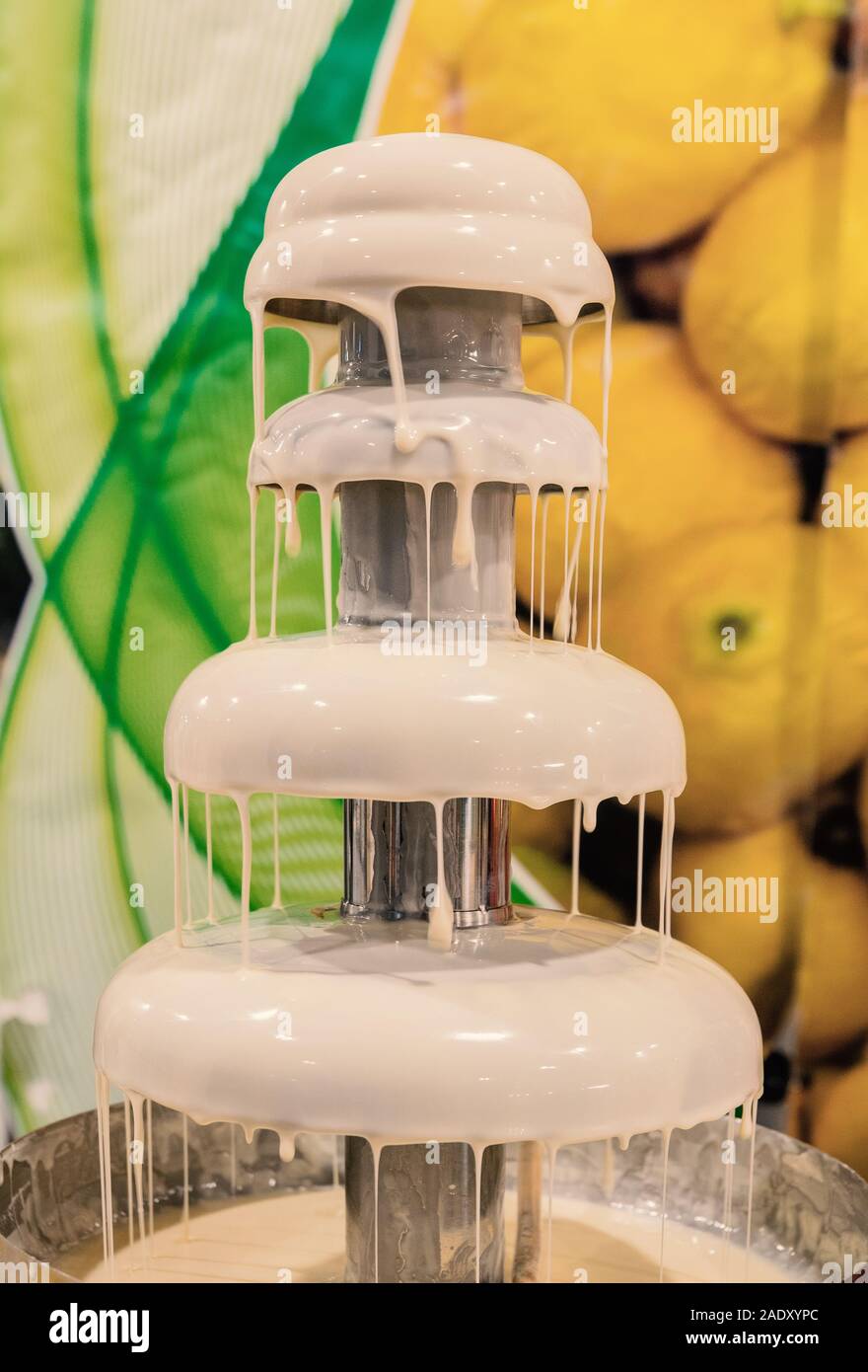 melted white chocolate fountain Stock Photo Alamy