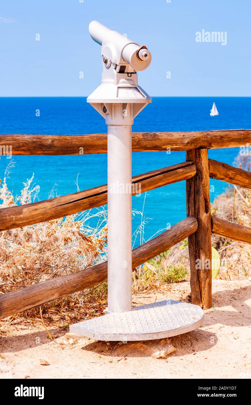 Stationary touristic telescope made of metal on one leg standing on the  edge of a cliff near the wooden logs fence and observes the Tyrrhenian sea  wit Stock Photo - Alamy