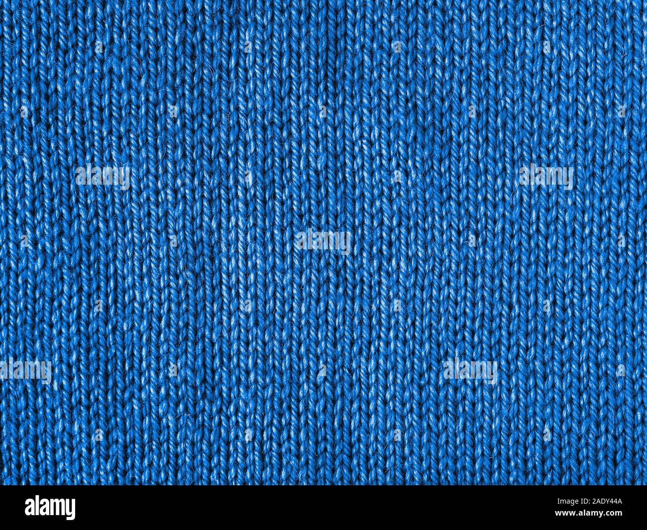 Blue knitted Jersey as textile background. Trendy blue color textule as color 2020 concept. Copy space for text and design. Stock Photo