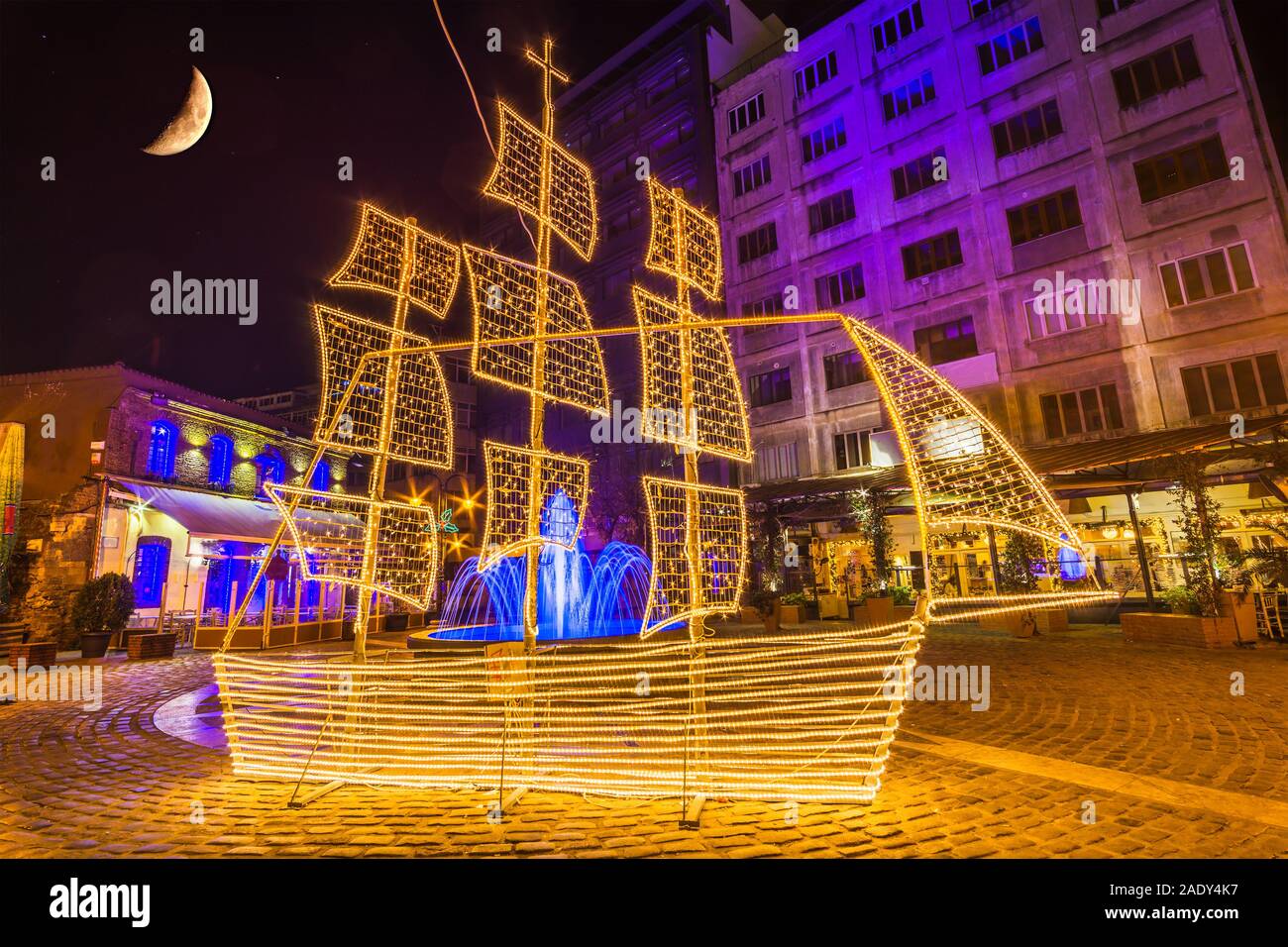 Beautiful urban decoration for Christmas period in a busy city center district. Traditional Greek custom of an illuminated Ship for Christmas. Stock Photo