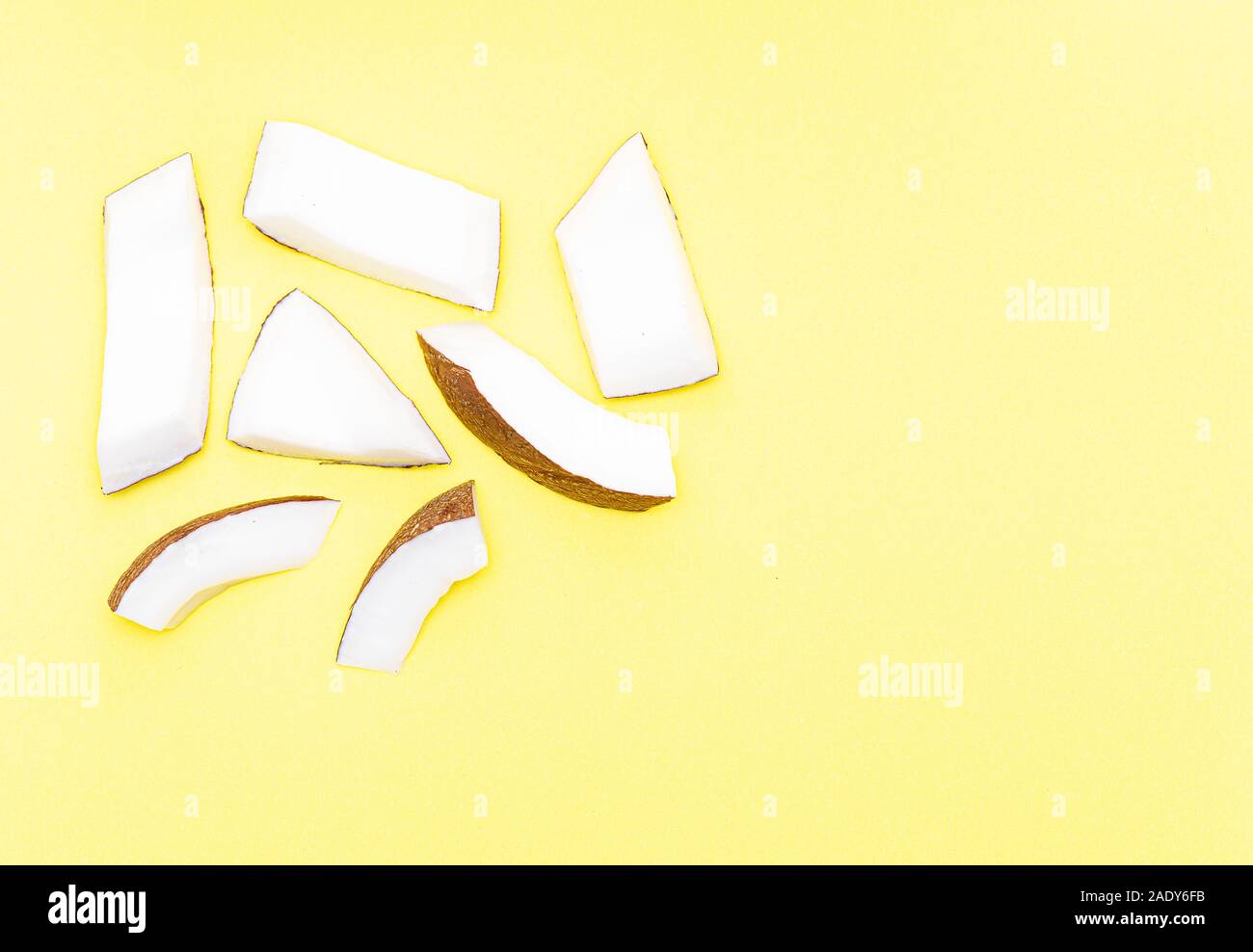 Coconut Pieces, Cut Coconut isolated on colored Background Stock Photo