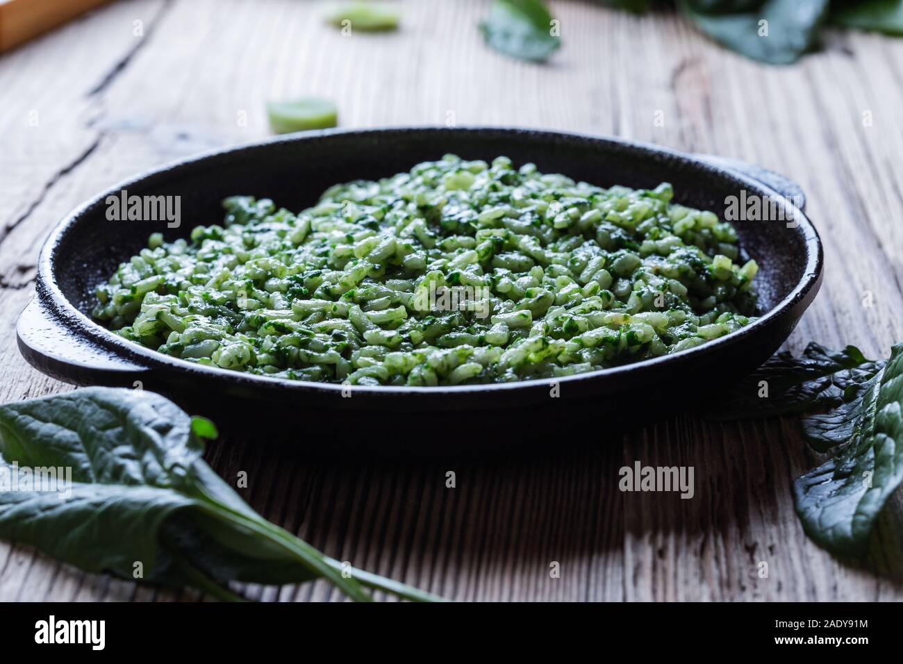 Vegan dish, spinach risotto in cast iron skillet, plant based vegan