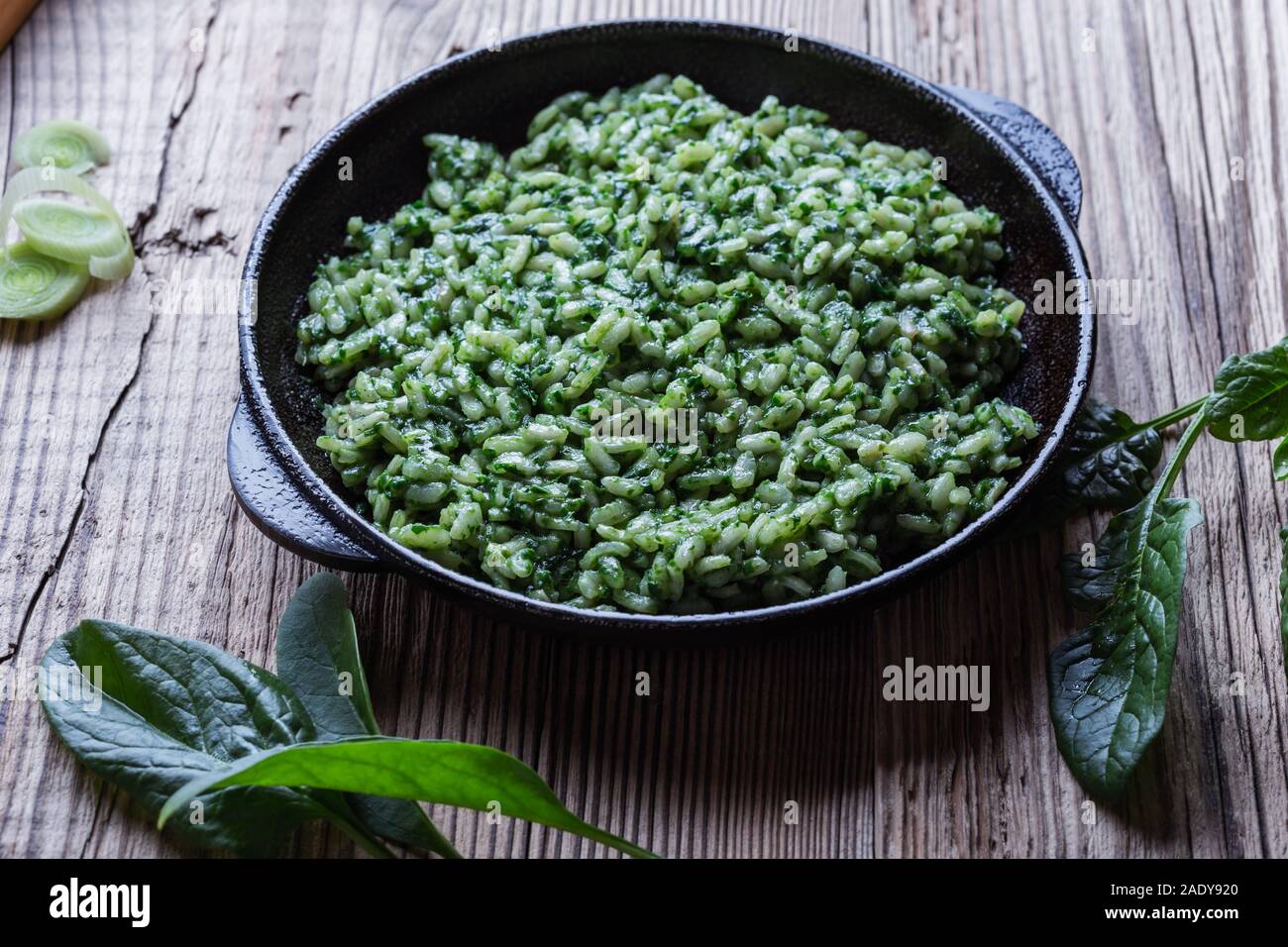 Vegan dish, spinach risotto in cast iron skillet, plant based vegan