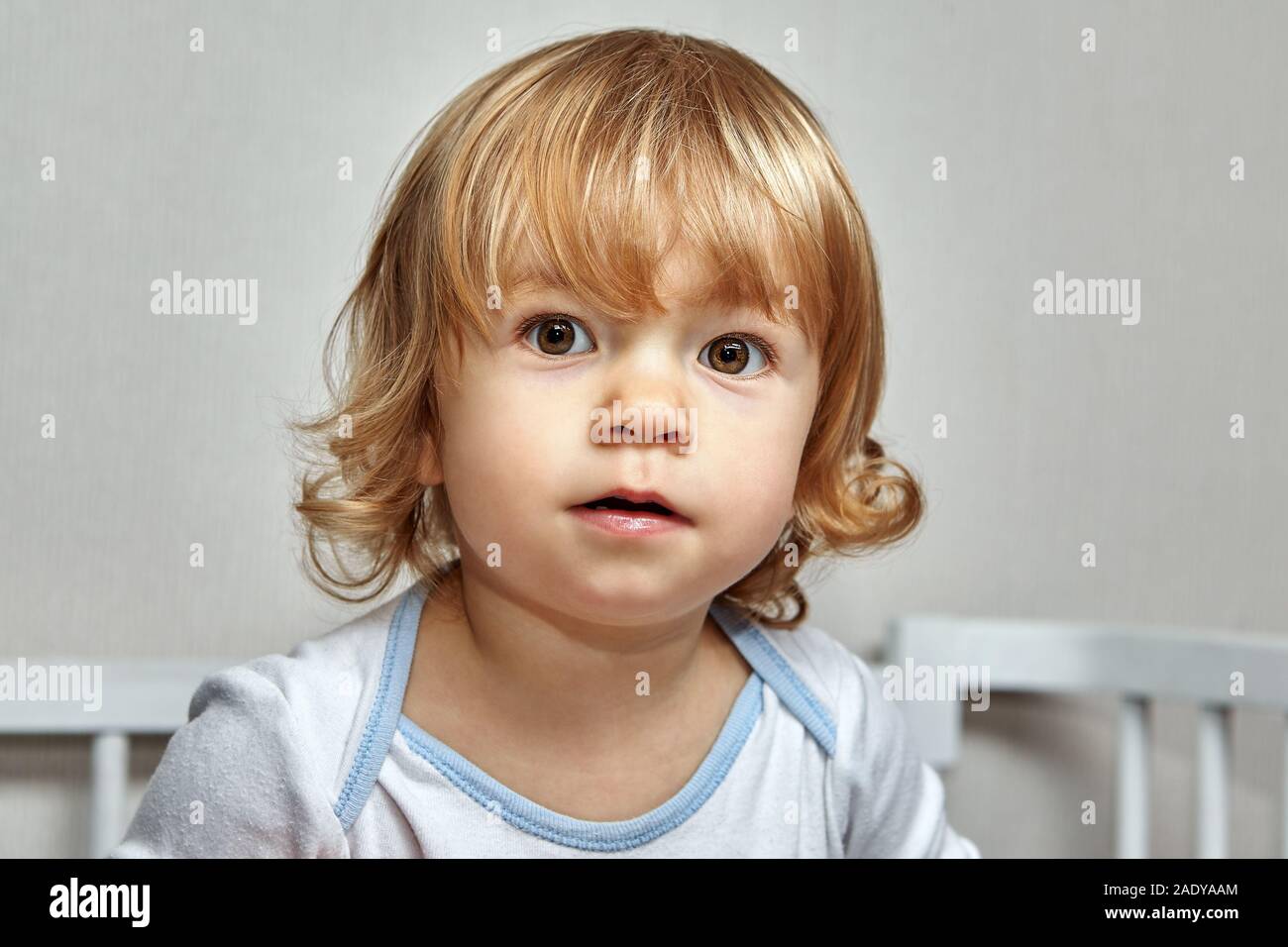 Portrait of charming white caucasian little child with blond curly hair and  brown eyes. Pretty baby girl about 2 years old, close-up Stock Photo - Alamy