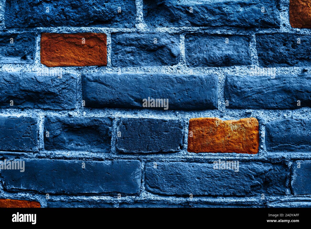 Close up image of old brick wall in blue color with some orange bricks. Background. Stock Photo