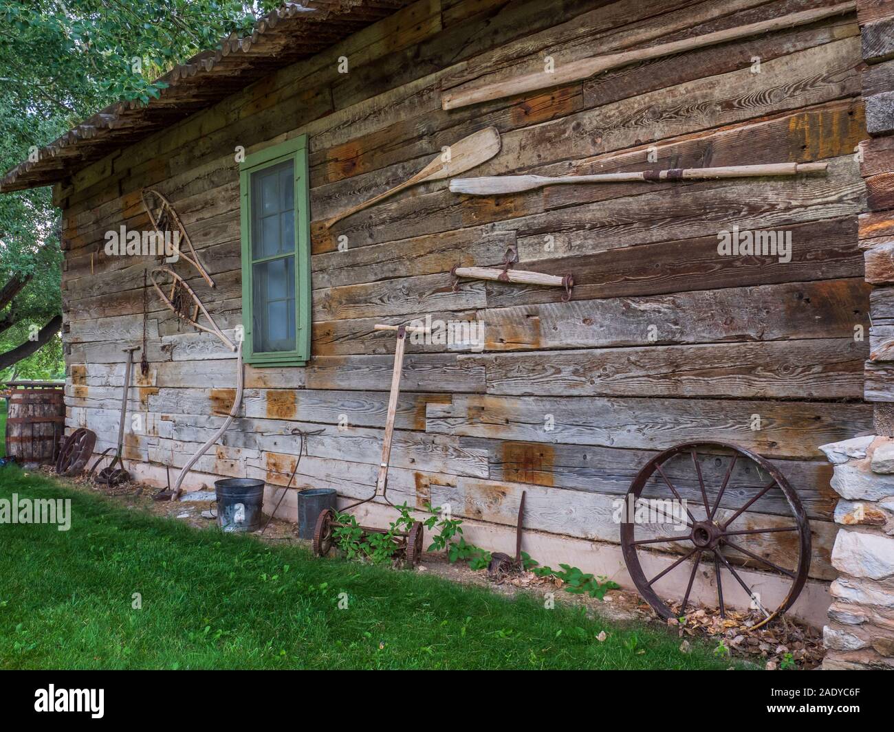 Equipment in front of Jarvie's store and home, John Jarvie Historic Property, Browns Park, Utah. Stock Photo