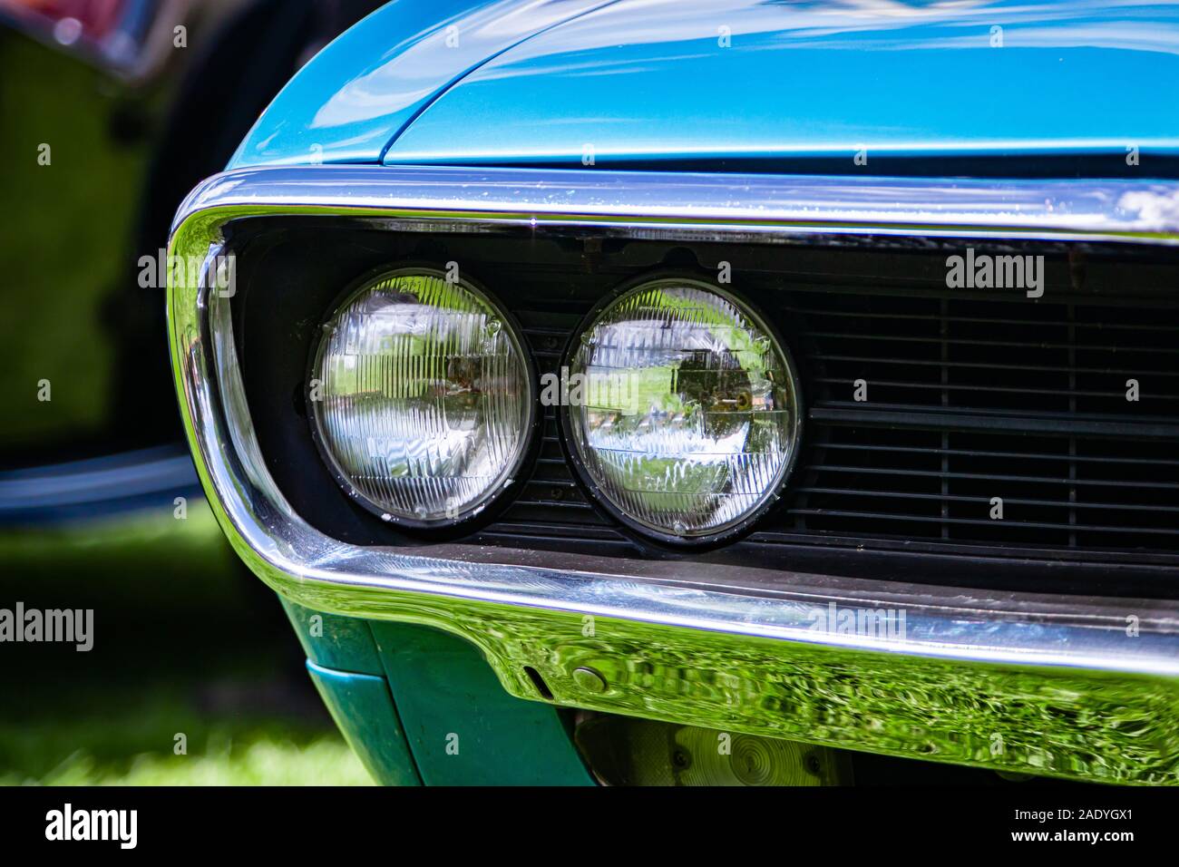selective focus on an old vintage American muscle blue car half front