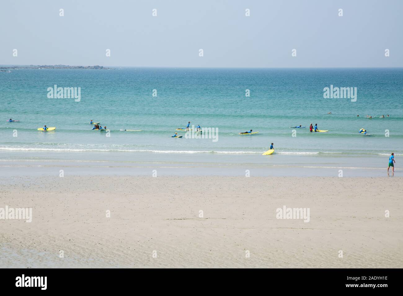Surfers learning to Surf in surfing school, Guernsey, Channel Islands Stock Photo