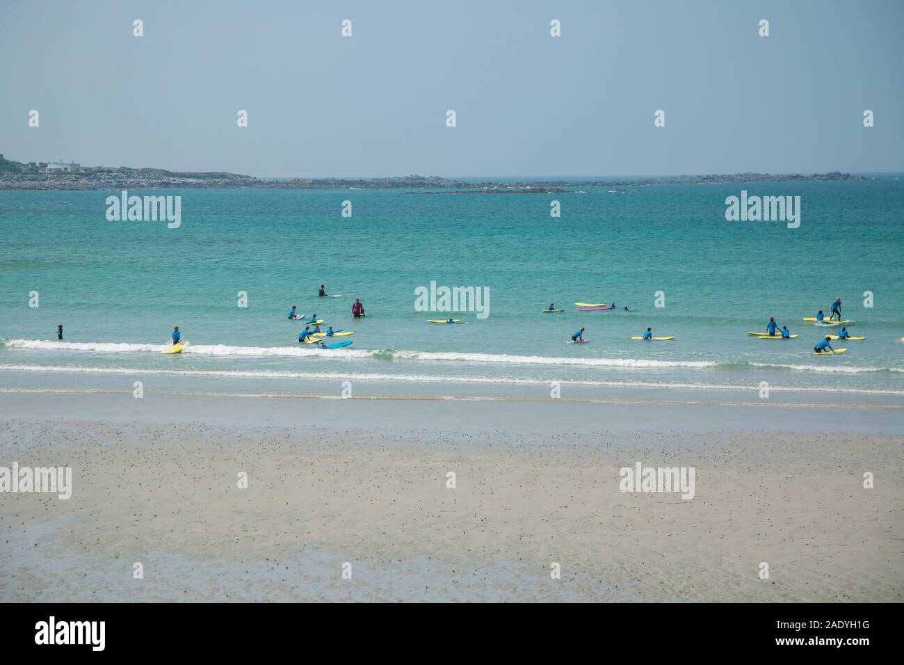 Blurred image of Surfers learning to Surf in surfing school, Guernsey, Channel Islands Stock Photo