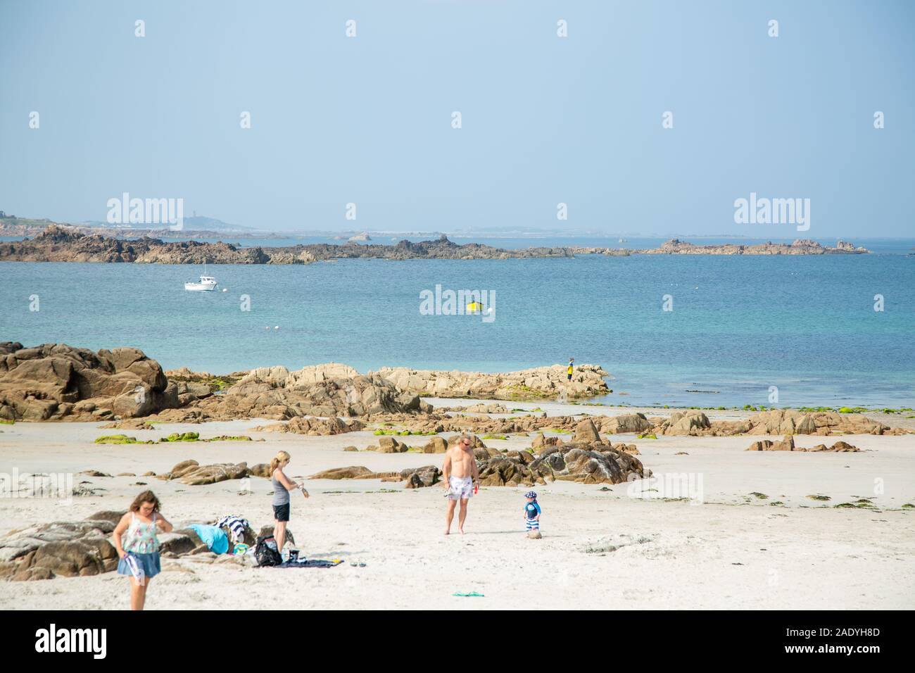 Family on the beach in the summer, channel islands Stock Photo
