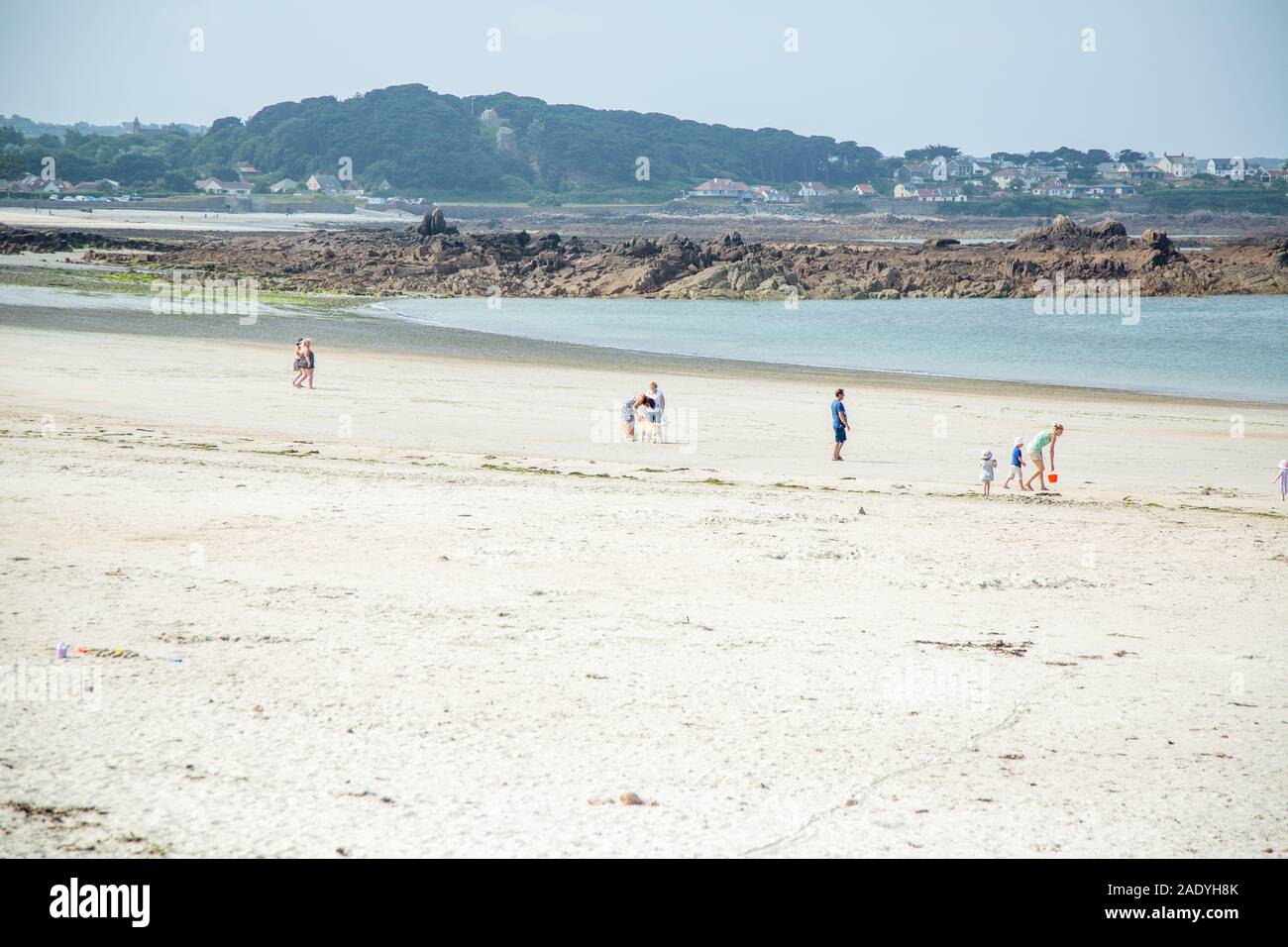 Family on the beach in the summer, channel islands Stock Photo