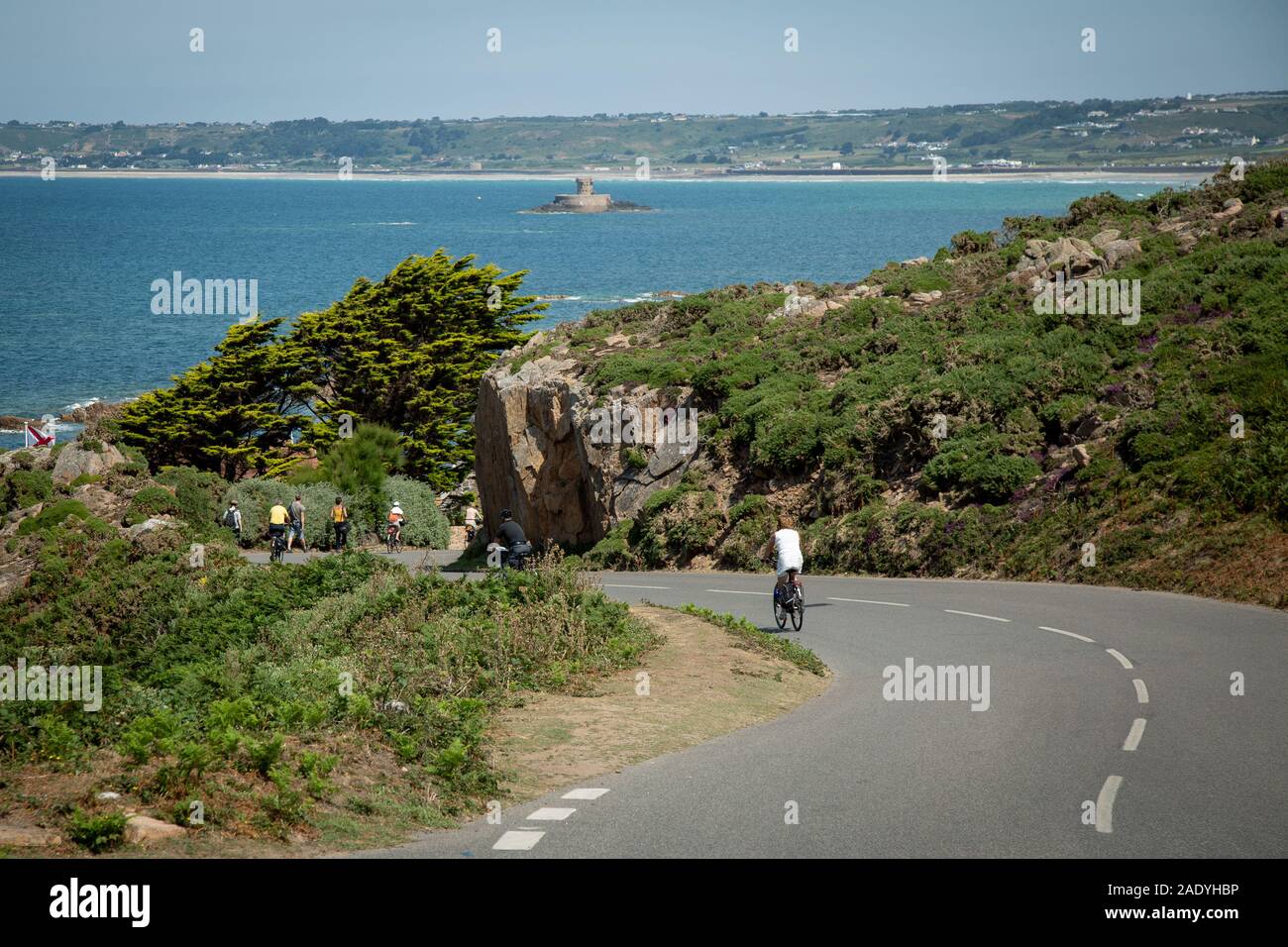 Cycling down the road in Jersey, Channel Islands Stock Photo