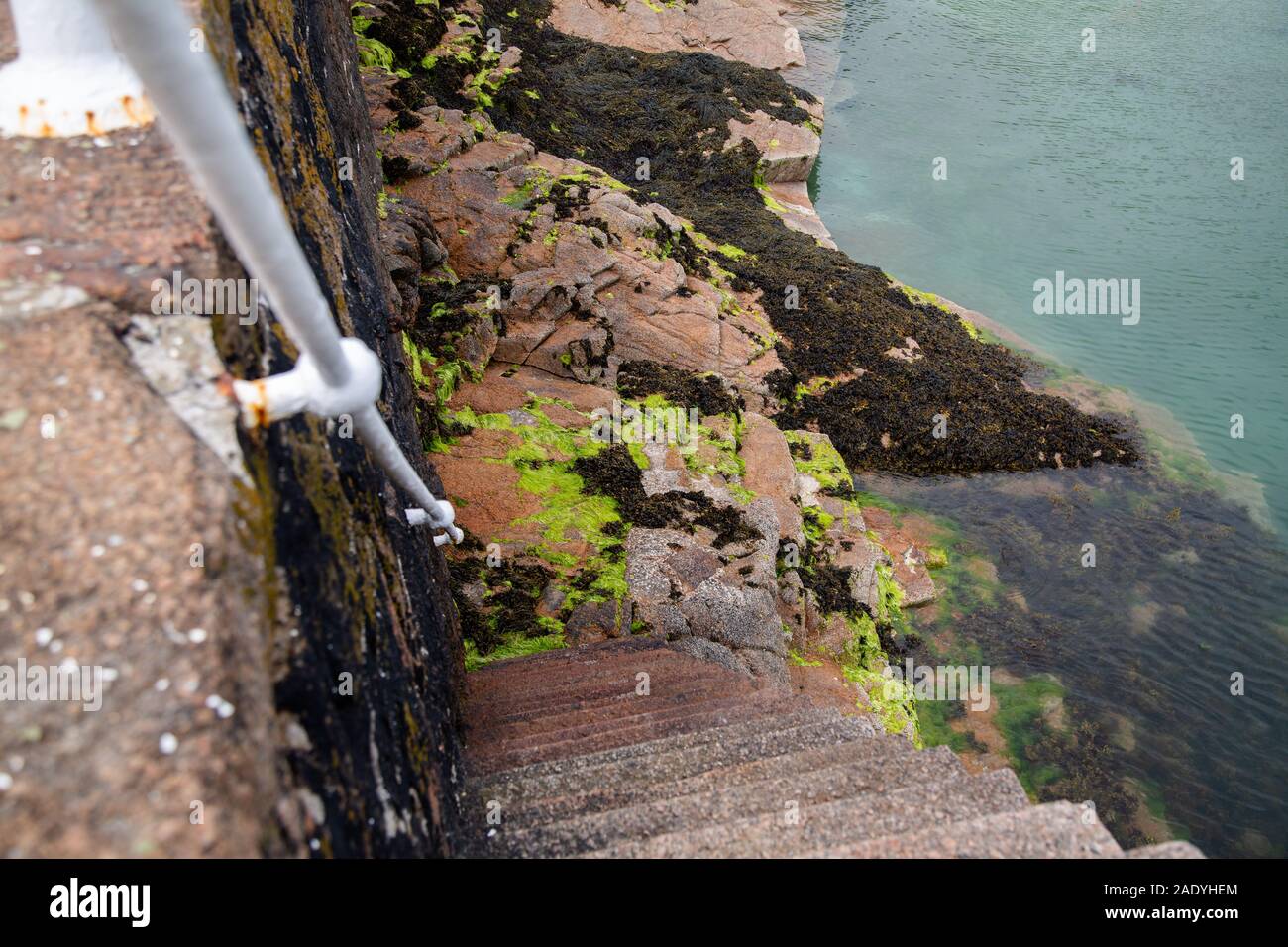Quayside walkway and stairs down to the sea, channel islands Stock Photo
