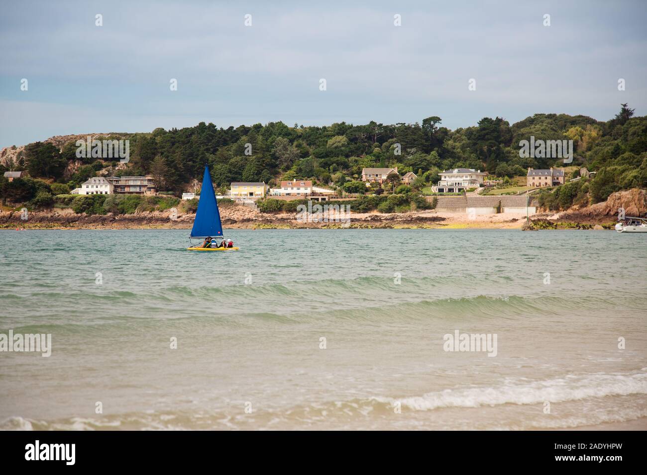 Sailing boat (dinghy) on the coast of Jersey, Channel Islands Stock Photo