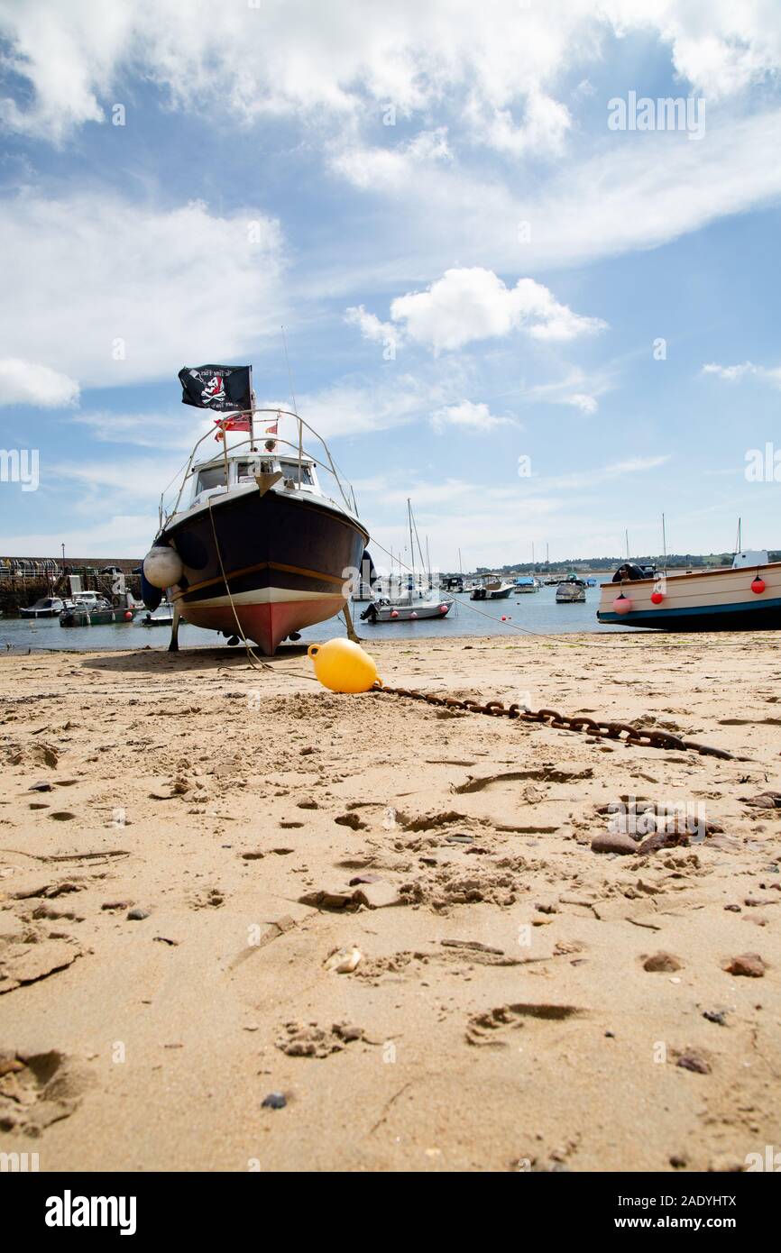 Boats on the beach waiting for high tide, Jersey Channel Islands Stock Photo