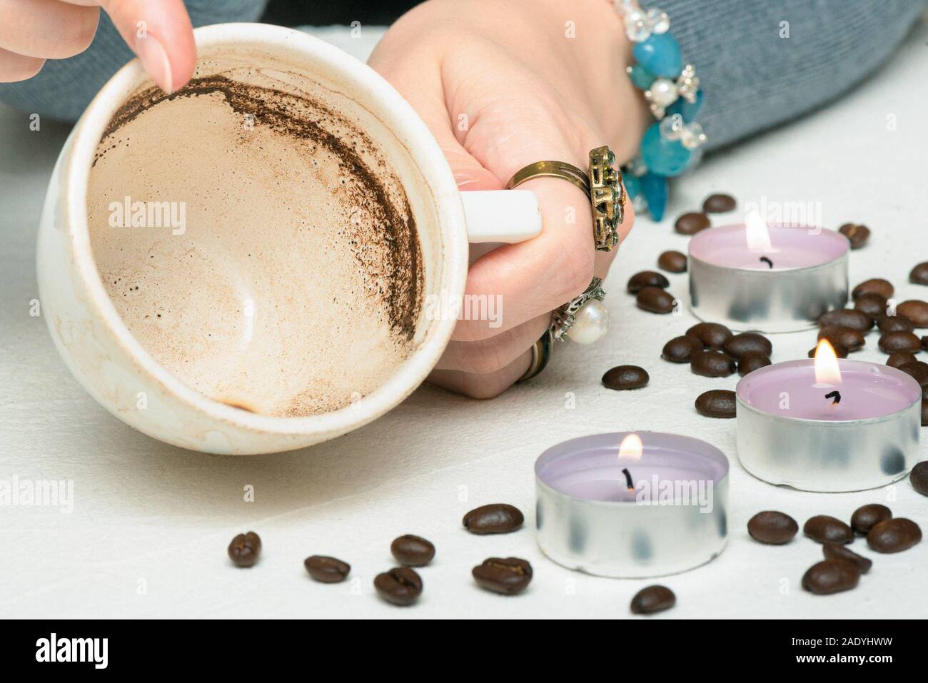 Coffee grounds fortune telling close up. Fortune teller with a cup of