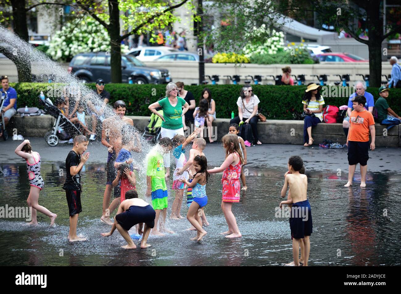 Chicago, Illinois, USA. Children play and cool off at Crown Fountain in Chicago's Millennium Park on a hot summer day. Stock Photo