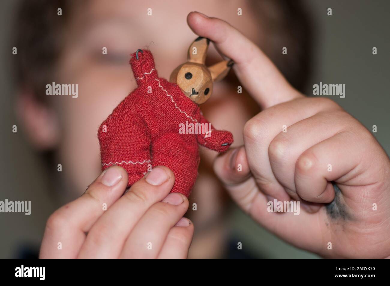 A child playing with rag wooden bunnies, analog toys Stock Photo
