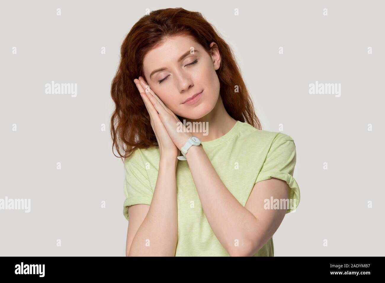 Calm millennial woman feeling sleepy head shot portrait. Stock Photo