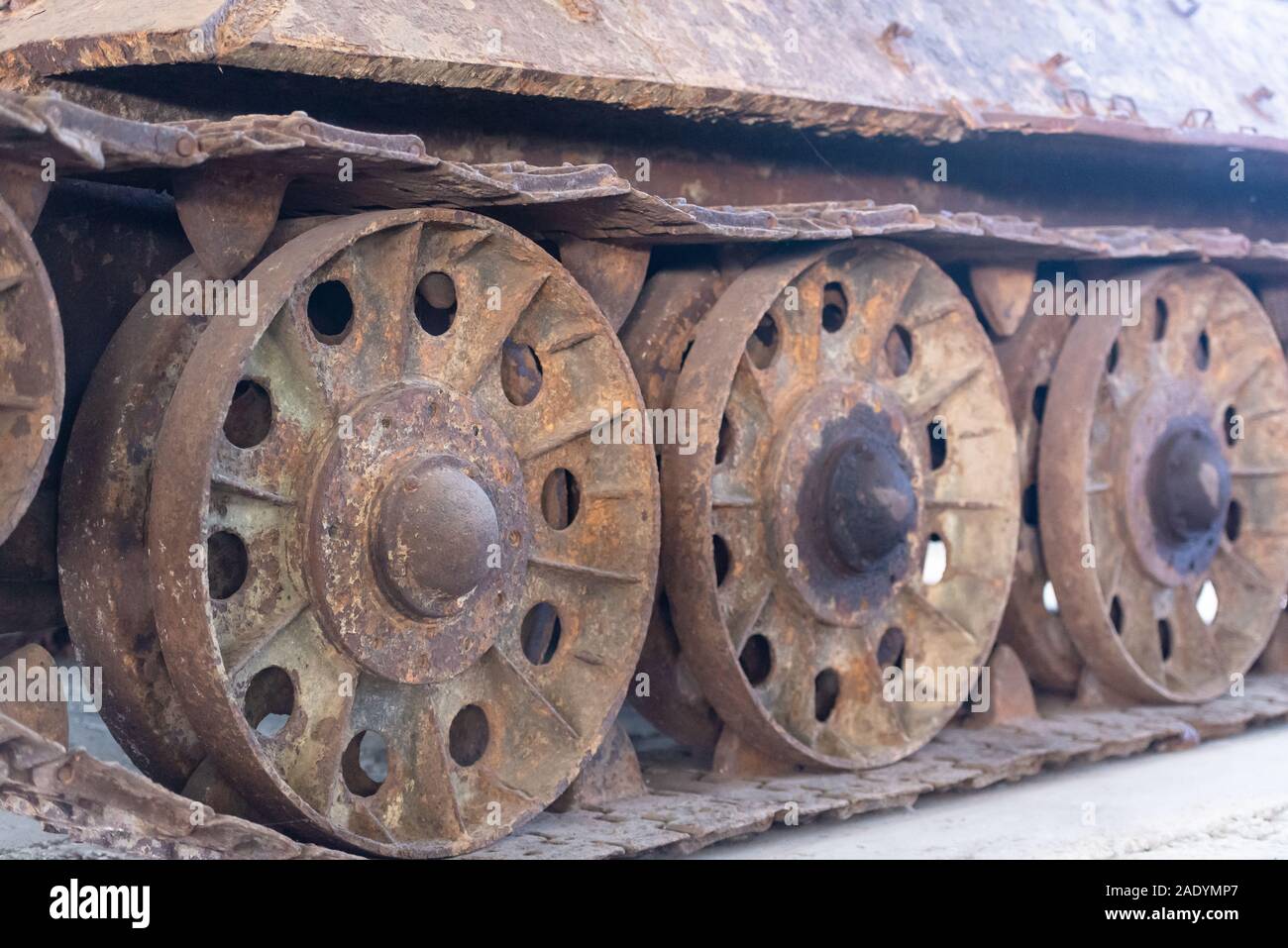 Old rusty caterpillar. Huge rusty wheels closeup. This tank had been in the swamp for fifty years. Stock Photo