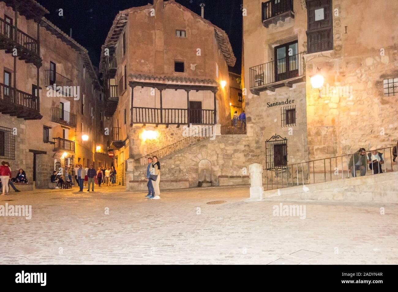 People tourists and holidaymakers in the evening  Plaza Mayor at the Medieval Moorish Ancient Spanish walled  city town of Albarracin Aragon Spain Stock Photo