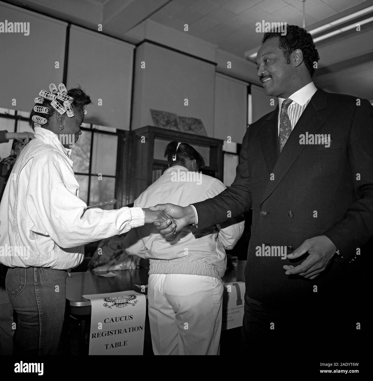 Jesse Jackson greeting a woman in hair curlers at a voting location in Detroit, Michigan when he was running for U.S. president. Stock Photo