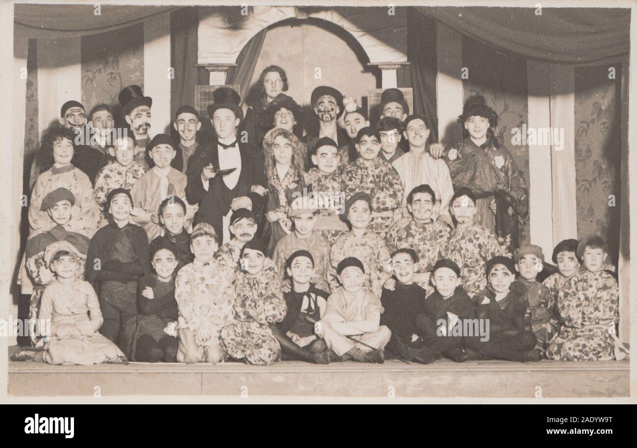 Vintage Early 20th Century Photographic Postcard Showing a Large Group of Children on a Stage in a Theatrical Performance. Stock Photo