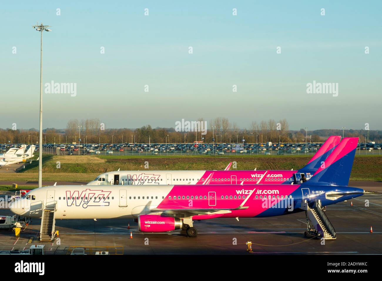 Two Airbus 321-200 aircrafts or passenger jets of Wizzair budget airline on the tarmac at London Luton Airport, England, UK Stock Photo