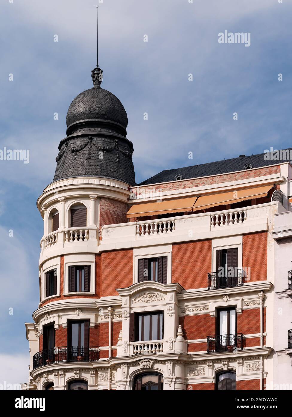 Close-up of Eclectic style apartment building with architectural dome made of slate tiles Stock Photo
