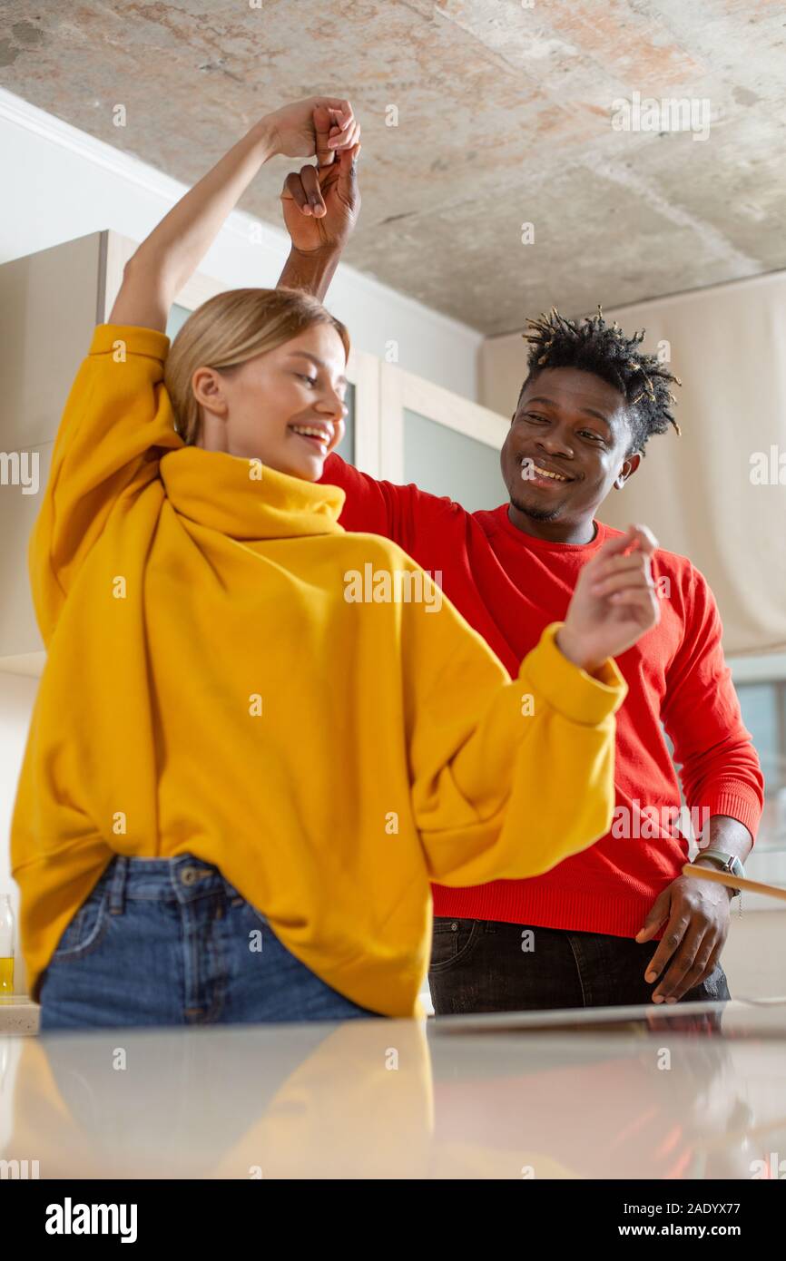 Waist up photo of two happy people dancing and smiling Stock Photo