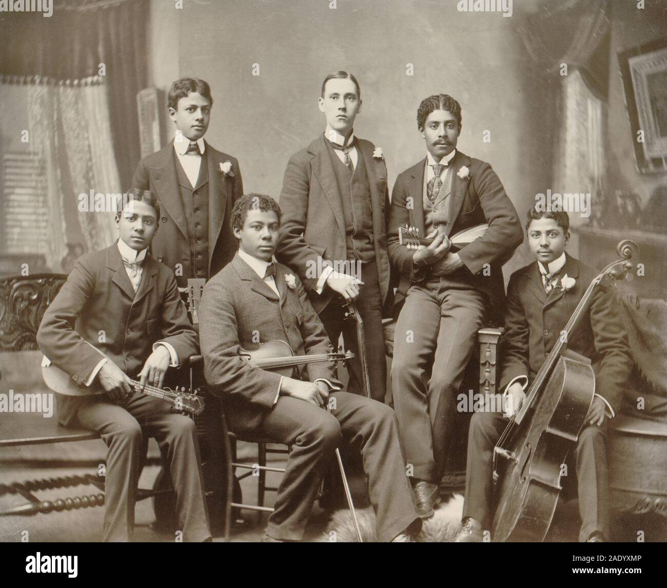 Summit Avenue Ensemble, Atlanta, Georgia - Photograph shows a group of six young men posed with their instruments in the photographer's home studio on Summit Avenue, Atlanta, Ga. From left: the photographer's twin sons Clarence and Norman Askew, son Arthur Askew, neighbor Jake Sansome, and sons Robert and Walter Askew. Circa 1900 Stock Photo