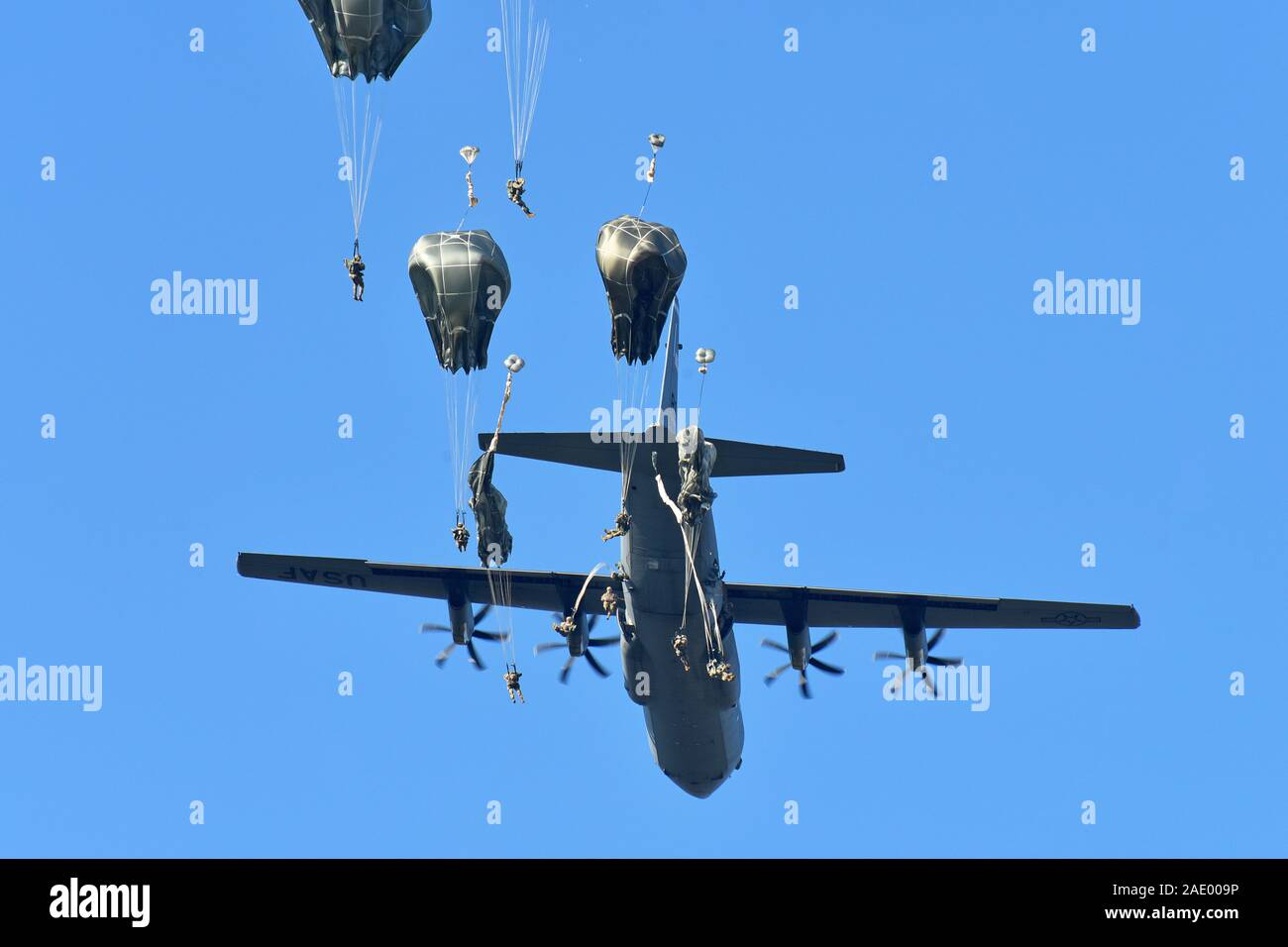 U.S. Army Paratroopers assigned to the 173rd Airborne Brigade with British and Italian Army paratroopers, exit a U.S. Air Force C-130 Hercules aircraft from the 86th Air Wing during airborne operation at Juliet Drop Zone, Pordenone, Italy Dec. 3, 2019. The 173rd Airborne Brigade is the U.S. Army Contingency Response Force in Europe, capable of projecting ready forces anywhere in the U.S. European, Africa or Central Commands' areas of responsibility. (U.S. Army Photo by Paolo Bovo) Stock Photo