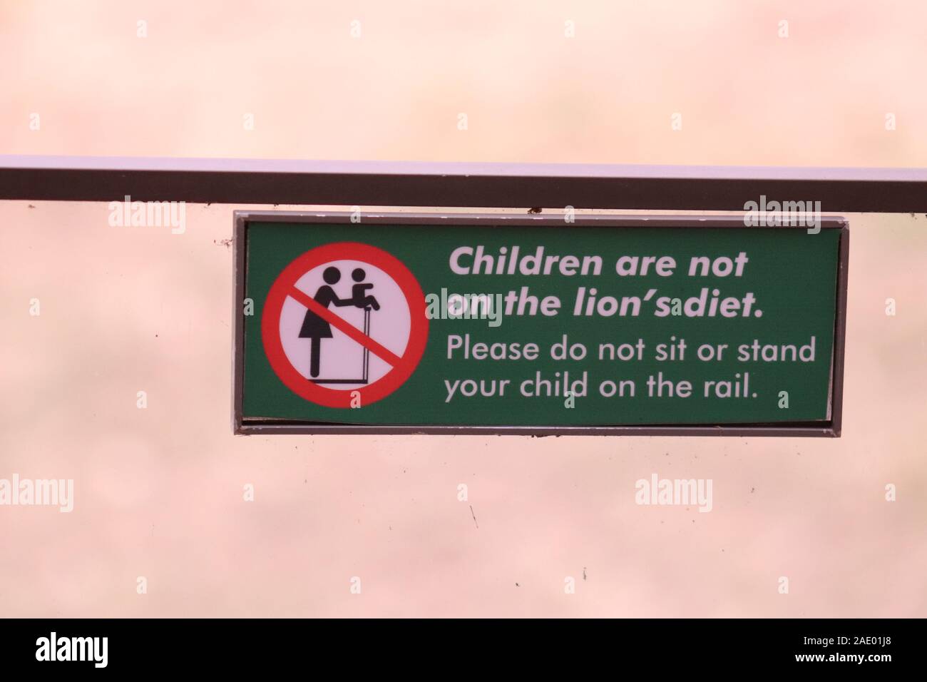 Children are not on the lion's diet.  Please do not sit or stand your child on the rail. Stock Photo