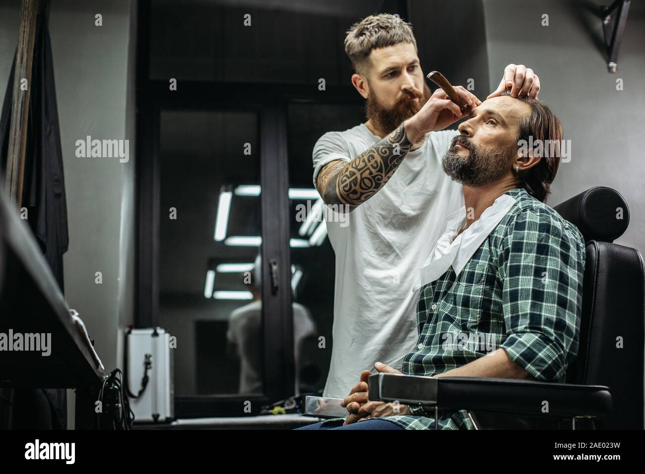 Professional barber using straight razor hi-res stock photography and ...