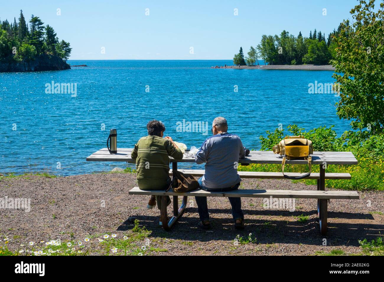 couple man and woman picnic on shore at Lake Superior State Park Split Rock Lighthouse State Park Stock Photo